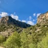 A mountain with a clear blue sky in the background.