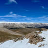 A mountain with a blue sky in the background.