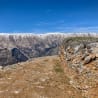 A rocky path winds up the side of a mountain.