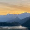 A view of mountains at sunset with a lake in the valley below.