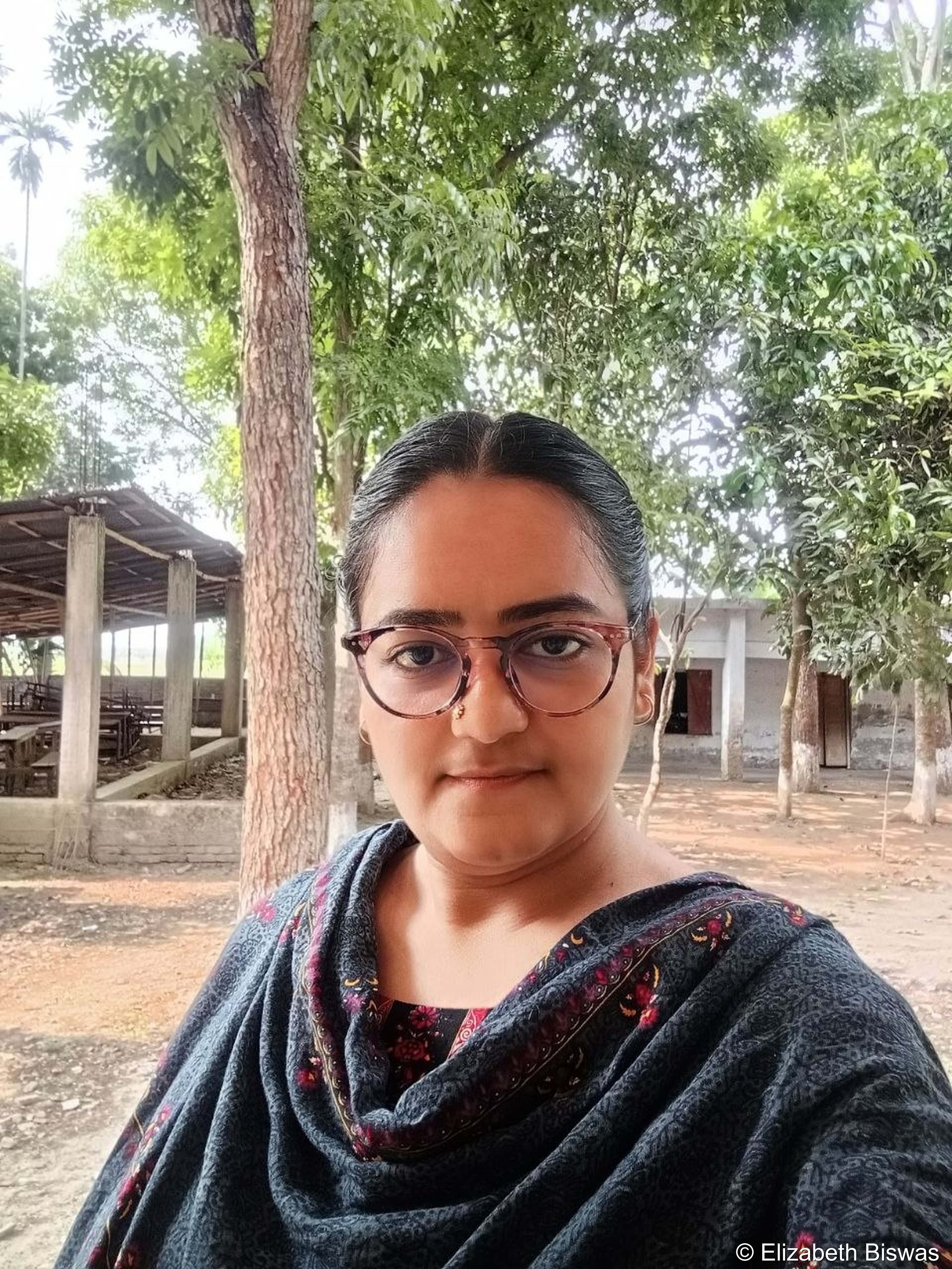 Woman in Traditional Attire at Rural Outdoor School