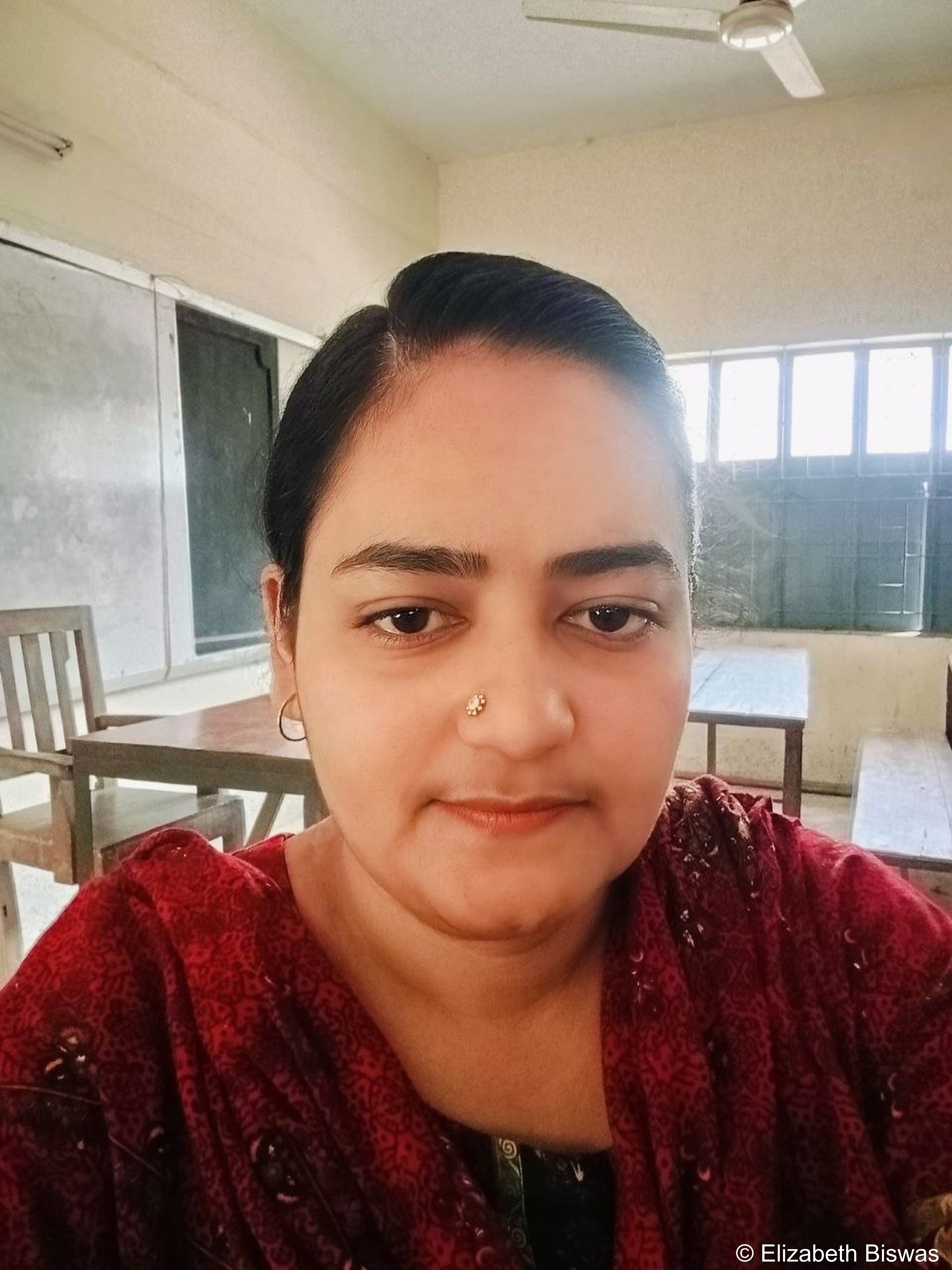 Portrait of a Female Teacher in a Classroom Setting