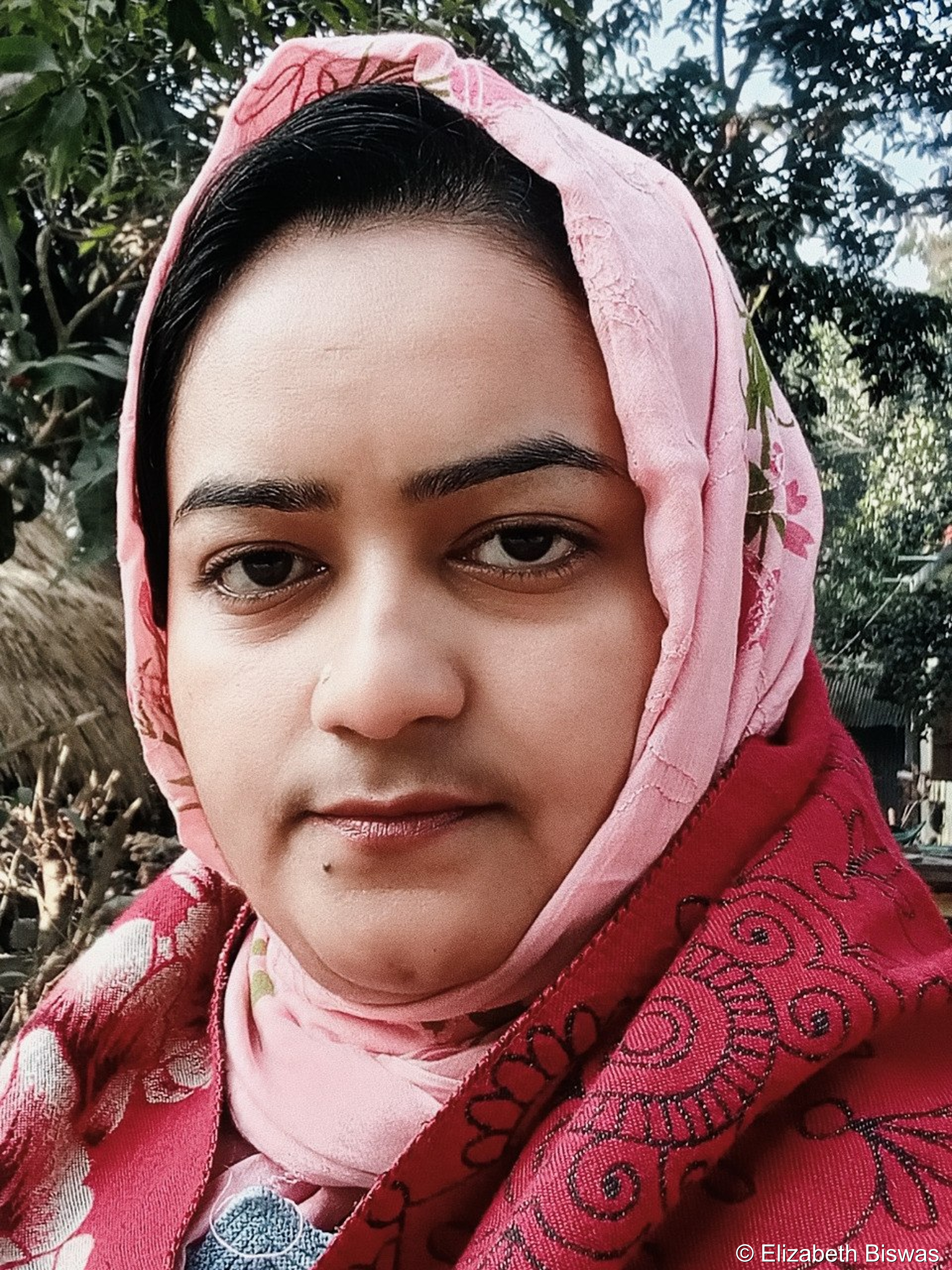 Portrait of a Woman in Pink Hijab and Red Shawl