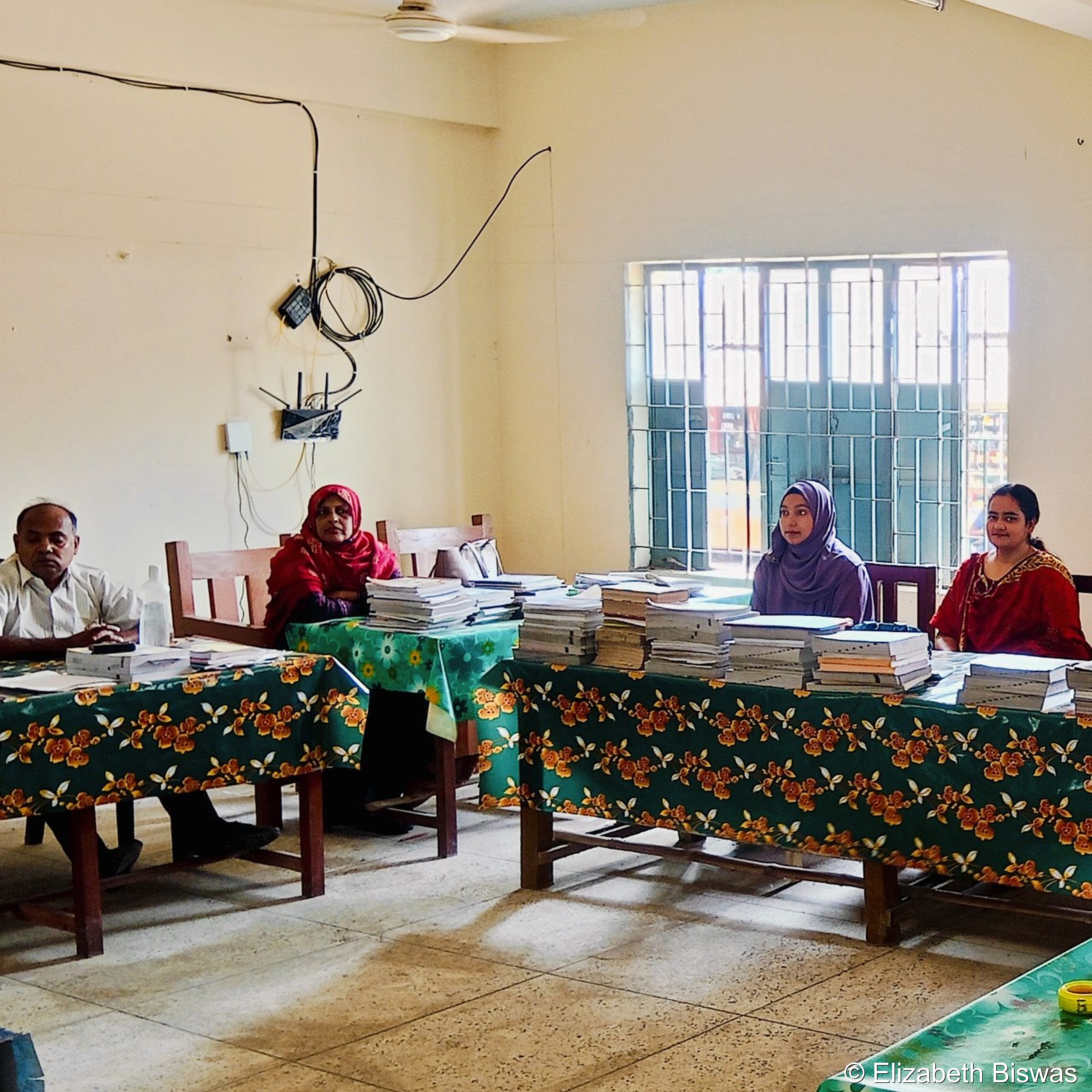 Dedicated Teachers Reviewing Exam Papers at School