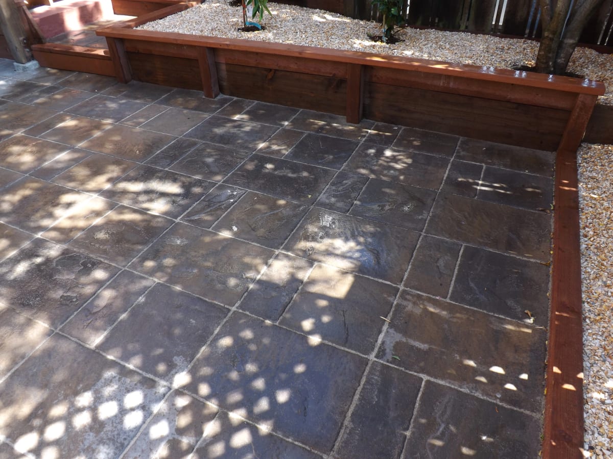 Tile patio with rock bed and desert plants