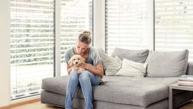 Frau mit Hund auf Sofa