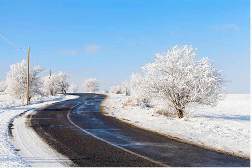 winterliches Bild mit Straße und Schnee bedeckten Bäumen