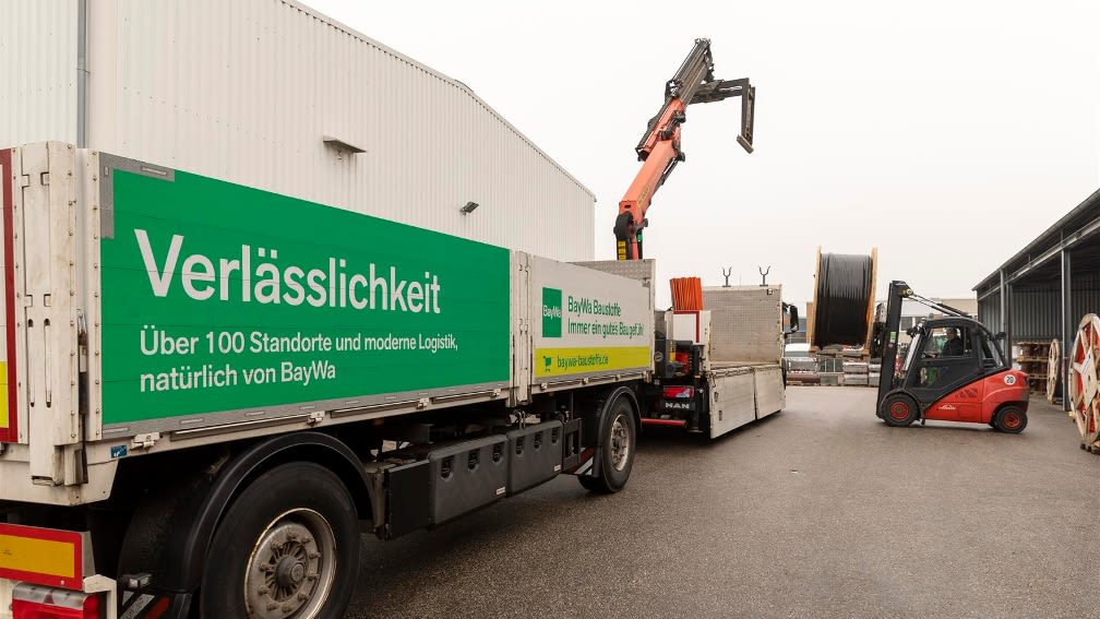 Lorry and forklift truck on building materials yard