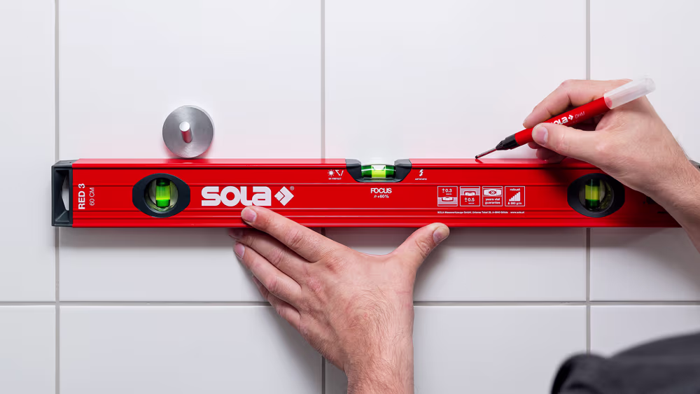 Sola Wasserwaage an Wand in Benutzung