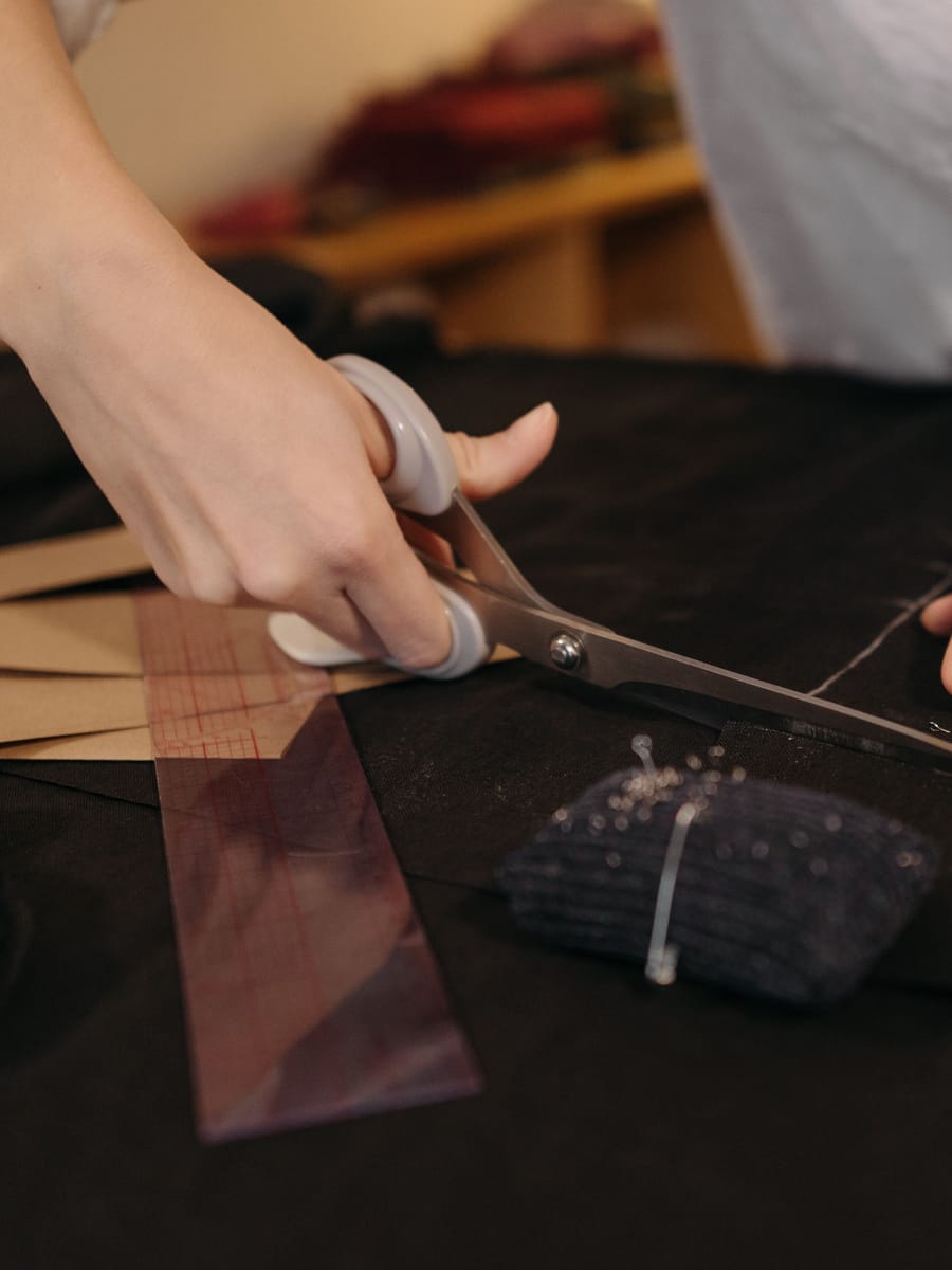 Cutting cloth by hand along the chalked pattern