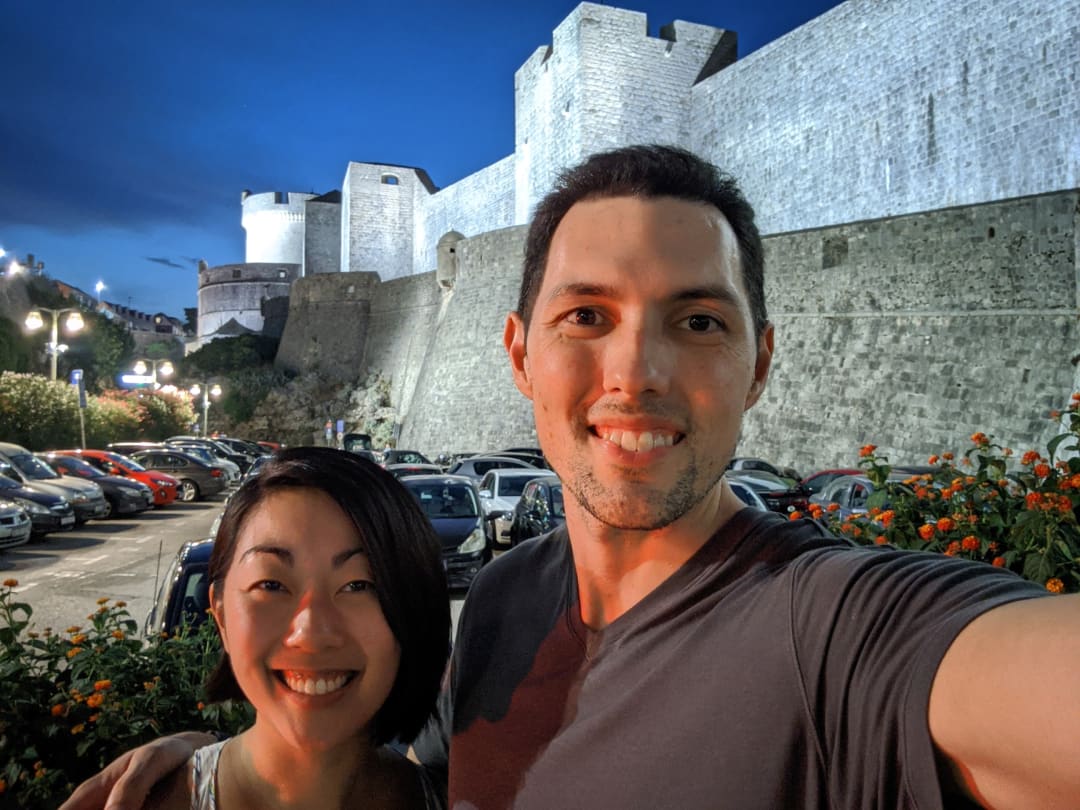 Selfie in front of city walls by parking lot