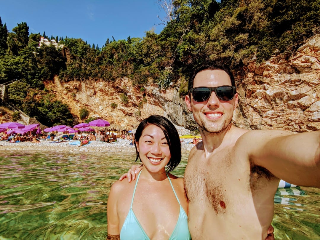 selfie in front of the beach with a high cliff