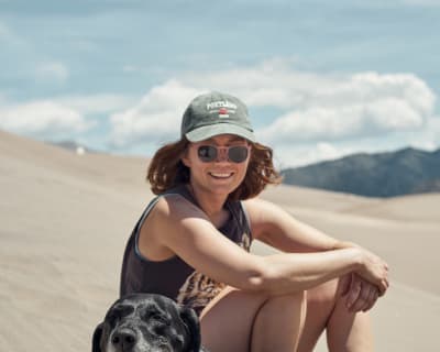 Two cuties taking a break on the sand dunes during a hot day.