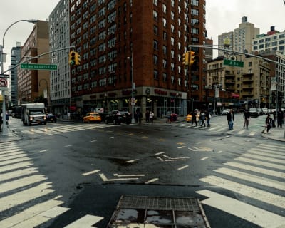 A busy intersection in New York City during a rainy day.