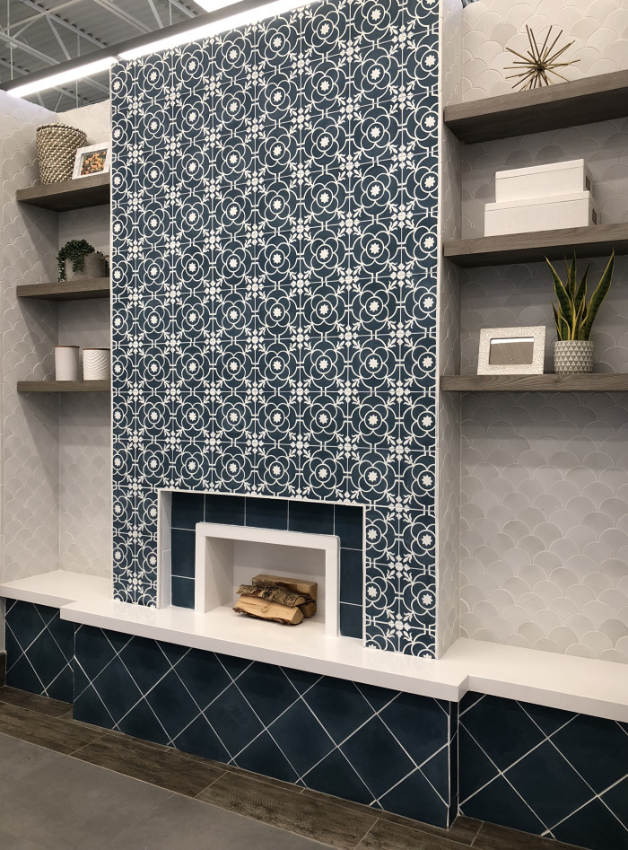 Main wall: Remy 8x8 cement tile in Brigette | Bookshelf walls: Paseo terra cotta tile Conche shape in Sierra White | Fireplace Bench: Sequel Quartz 2cm polished slab in Arlington White | Fireplace Bench Face: Remy 8x8 cement tile in Cobalt | Floor: River Wood 8x24 wood-look tile in Walnut