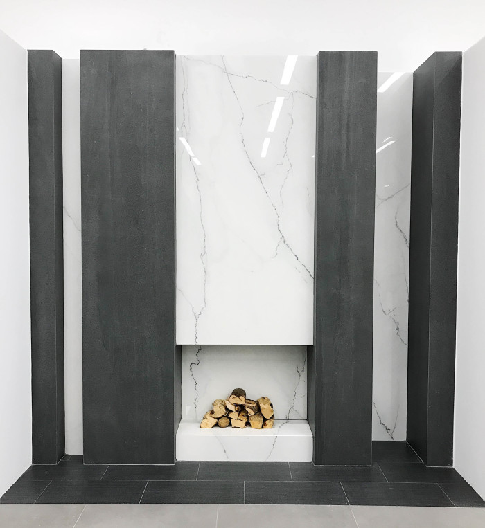 Fireplace inset: Magnifica® Porcelain in Lincoln Super White | Fireplace columns: Magnifica® Porcelain in Basalto | Floor: Stands 12x24 porcelain in Black