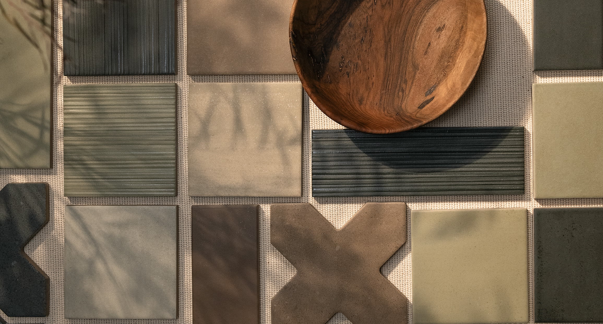 Hikari Cross, field tile and linear relief deco in Clay, Sage, Ebony and Brown in afternoon sun