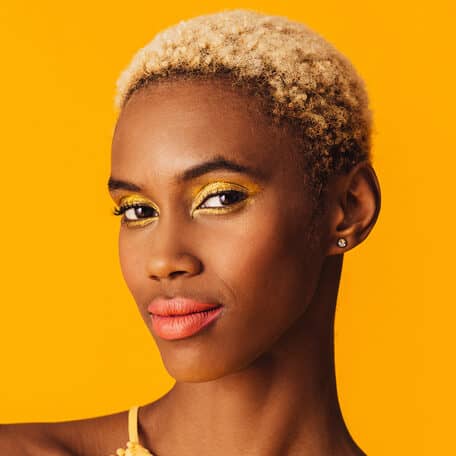 Imagem de mulher com maquiagem e roupa na cor amarela