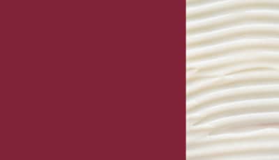 Uma imagem com um produto de cabelo ao lado de um fundo vermelho.