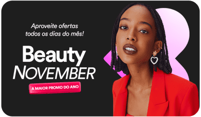 Mulher negra com penteado trançado, vestindo um blazer vermelho, em um fundo preto, comunicando a Beauty November, a maior promoção do ano.