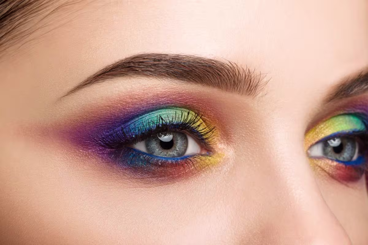 Maquiagem multicolorida que representa a colorimetria de cores triádicas