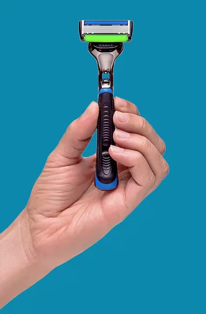 Foto do aparelho de barbear THE RAZOR6, da Dr. JONES, em fundo azul e sendo exibido por uma mão de pessoa de pele clara. O aparelho tem cabo escuro emborrachado de metal, seis lâminas na cabeça, fita lubrificante azul na parte superior da cabeça e faixa de segurança verde na parte de baixo.