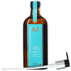 A imagem mostra o Óleo Cpailar Moroccanoil em frasco âmbar de 200ml. Embalagem retangular com rótulo azul turquesa e logotipo M em laranja. Na parte de baixo, um aplicador de plástico branco e preto acompanha o frasco.