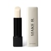 Balm labial Make B. em embalagem preta e branca, com texto "Make B." impresso. O produto possui formato cilíndrico e cor bege clara, sugerindo um batom ou produto labial.