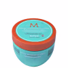 A imagem mostra a Máscara Capilar Moroccanoil Repair 500ml, um pote redondo de plástico na cor azul turquesa com detalhes em laranja. As informações sobre o produto estão escritas em inglês e espanhol no rótulo do pote.