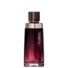Frasco de perfume Malbec com design elegante em tons de vermelho e dourado, contendo líquido de cor rosada. O rótulo exibe o nome da marca em destaque.