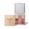 Embalagem compacta retangular de plástico cromado com espelho interno. A caixa externa é bege com o logotipo "Eudora Glam Metals" em letras douradas. Contém 9 sombras prensadas em tons terrosos, rosas, marrons e dourados com acabamento metálico brilhante.