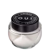 Frasco de vidro transparente com tampa preta redonda contendo produto da marca O.U.i. O rótulo preto destaca o nome da marca e a declaração "Unique Original Indulgent" em letras brancas.