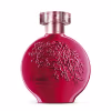 A imagem mostra um frasco de perfume da linha Floratta Red. O frasco tem um design arredondado e é feito de vidro vermelho brilhante. A parte superior é de metal rosado. O nome "Floratta Red" está inscrito em letras elegantes na parte inferior do frasco.
