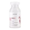 Frasco branco com rótulo "BRAE Blonde Oil" e texto em inglês e português, contendo uma ampola de tratamento para cabelos loiros.