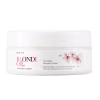 Embalagem branca com rótulo da linha Braé Blonde Oil, contendo máscara capilar regeneradora para cabelos loiros. Apresenta flores rosa na embalagem, indicando o aroma e propriedades do produto.
