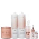 Conjunto de produtos da marca Braé, incluindo um frasco de shampoo, condicionador, sérum, spray e máscara de reconstrução capilar, em embalagens brancas e rosadas.