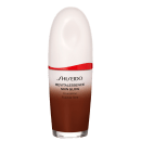 Base facial da marca Shiseido., Embalagem em forma de frasco plástico oval com uma faixa vermelha na parte superior. Rótulo indicando "Revitalessence Skin Glow Foundation" em letras pretas.