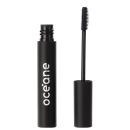A imagem mostra o Gel Incolor para Sobrancelhas Océane Purple Instant Brows, em um tubo preto cilíndrico com o nome "Océane" impresso em letras brancas e ao lado uma escova aplicadora de cerdas brancas espiraladas.
