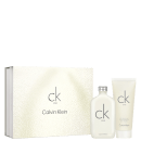 Um frasco de perfume transparente com tampa prateada e o logotipo "ck one" gravado no vidro. Uma caixa branca texturizada com o nome da marca "Calvin Klein" e o logotipo "ck one" em letras minúsculas cinza. Um tubo branco de loção corporal.