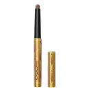 A imagem mostra uma sombra em bastão, em embalagem dourada, com detalhes vermelhos e logo da marca em preto. Ela está aberta, com a tampa ao lado.