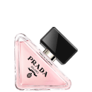 O frasco possui um formato triangular com uma tampa preta. A embalagem é predominantemente rosa, com o nome "PRADA" em preto destacado no centro. O rótulo também exibe o texto "Virtual Flower" em letras menores.