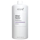 Frasco branco da linha Silver Savior da Keune, contendo shampoo prateado com aroma de flor violeta. Rótulo com nome da marca e produto em destaque.