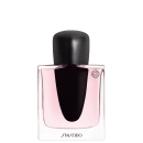 Frasco de perfume Shiseido com tampa preta e corpo em vidro rosa claro. O rótulo apresenta o nome da marca em letras brancas sobre fundo preto.