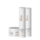 Conjunto de produtos Acquaflora para cabelos, incluindo shampoo, condicionador e creme em embalagens brancas com detalhes em dourado. Produtos com foco em proteção contra os efeitos do sol, água do mar e cloro.