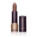 Batom bala da marca Eudora Make na cor Nude Destaque, com embalagem preta e dourada. O rótulo indica a linha "Kiss Me". O batom possui formato cilíndrico e apresenta uma textura opaca.
