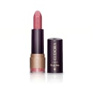 Batom bala da marca Eudora Make na cor Nude Realce, com embalagem preta e dourada. O rótulo indica a linha "Kiss Me". O batom possui formato cilíndrico e apresenta uma textura opaca.
