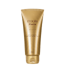 Frasco dourado de 100 ml da linha Kissme da Eudora, com textura aveludada e rótulo com o nome do produto "Delicious" e informações sobre o tipo de produto, que é uma loção iluminadora e desodorante hidratante corporal.