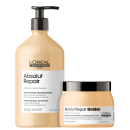 A imagem mostra dois produtos de cuidado capilar da linha Absolut Repair da L'Oréal Professionnel. Um é um shampoo em uma embalagem plástica na cor bege claro. O outro é uma máscara capilar em um pote plástico perolado na mesma cor bege.