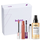 A caixa branca contém produtos de beleza, incluindo um batom líquido de cor rosada, uma máscara de cílios e um frasco de óleo de reparação da marca L'Oréal Professionnel.