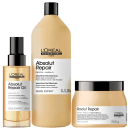 Produtos da linha Absolut Repair da L'Oréal Professionnel, incluindo um frasco de óleo, um frasco de shampoo e um pote de tratamento condicionante, todos em embalagens de design moderno e cores neutras.